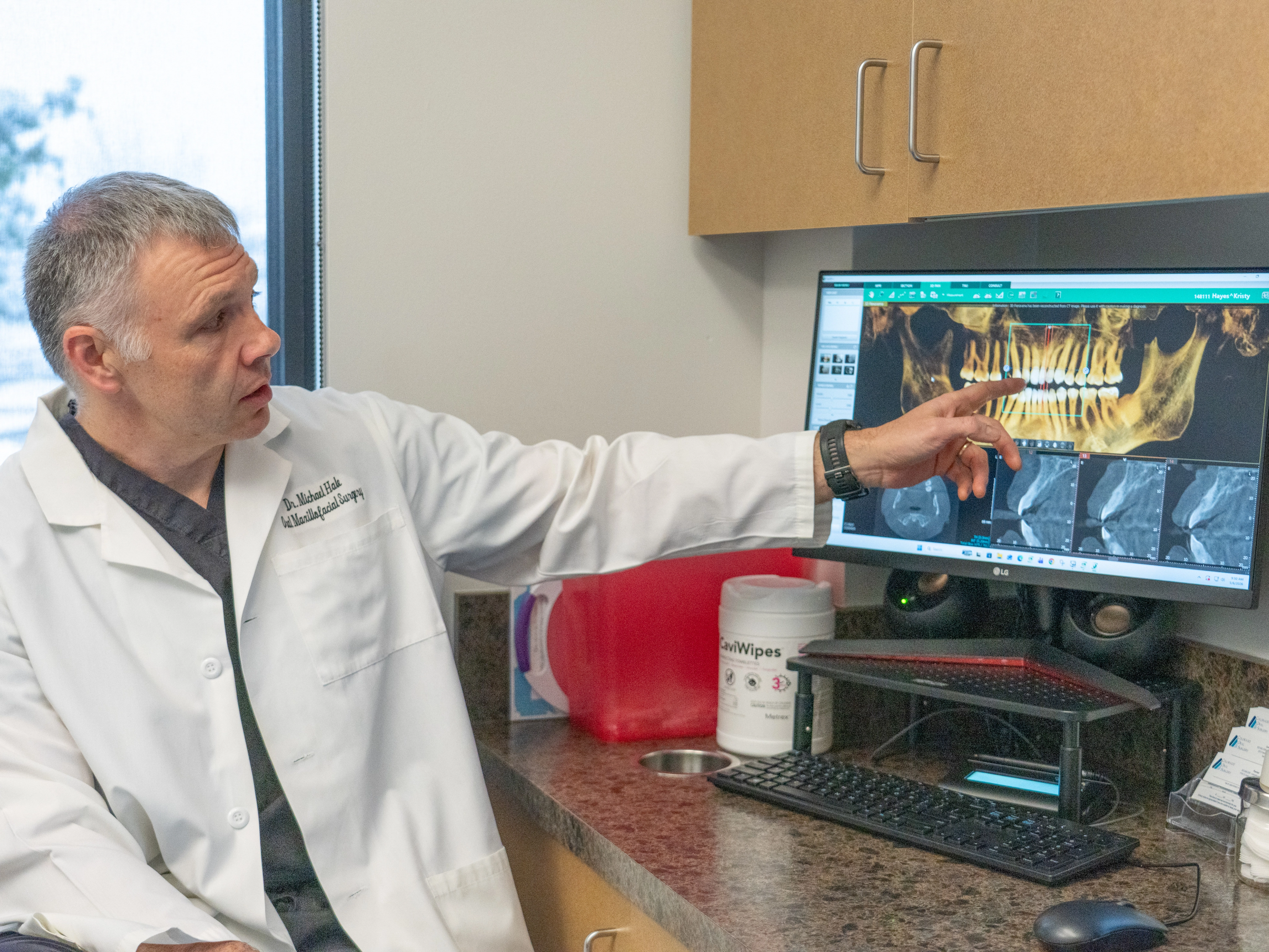 Doctor reviewing 3D imaging scan at Colorado Oral Surgery