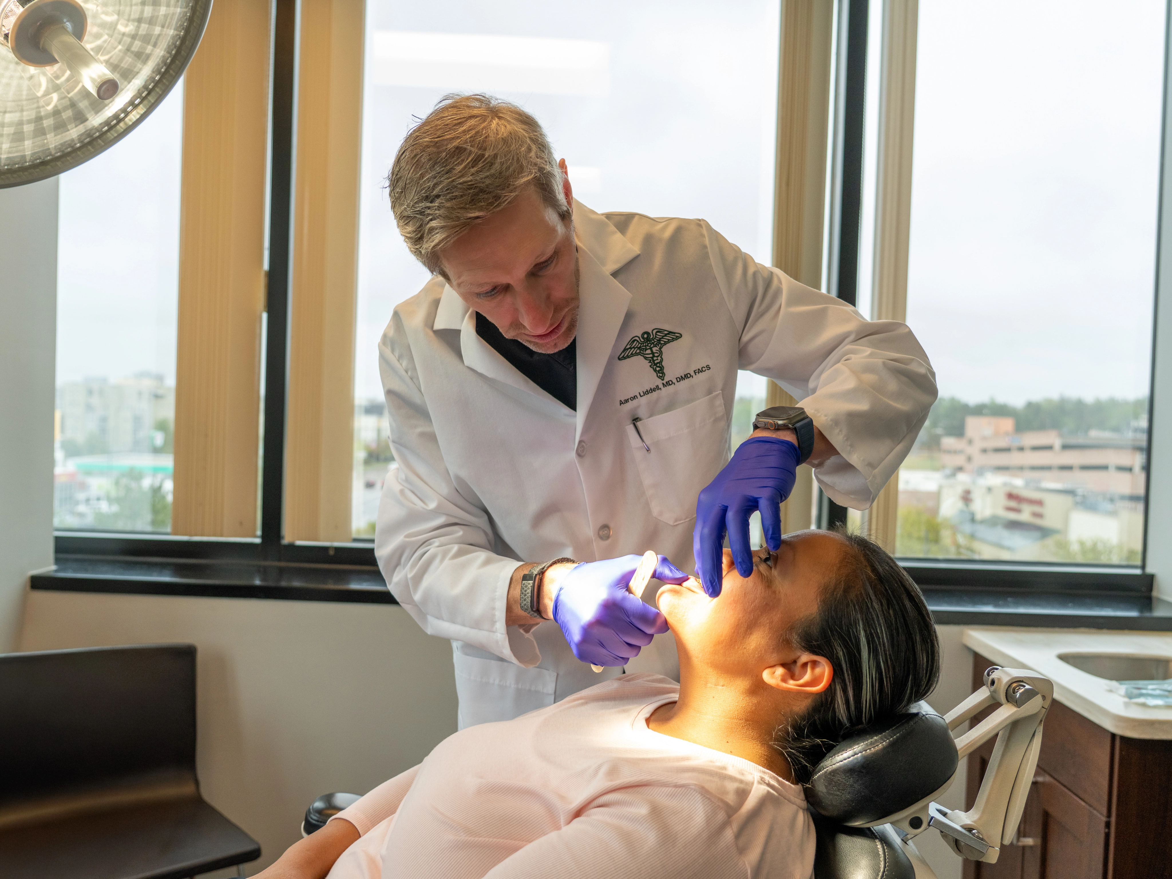 Dr. Liddell performing jaw examination at Colorado Oral Surgery